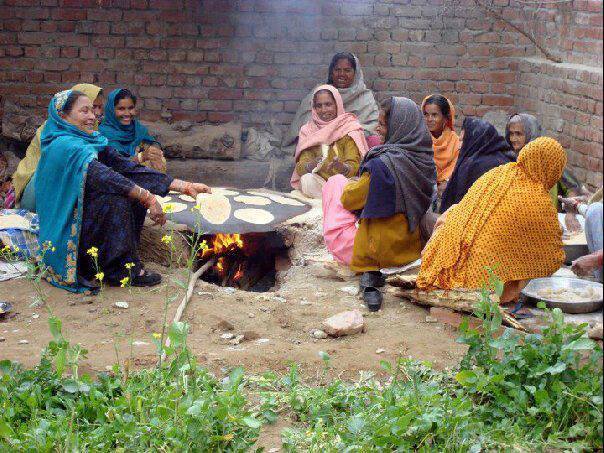 Village women in Pakistan preparing bread